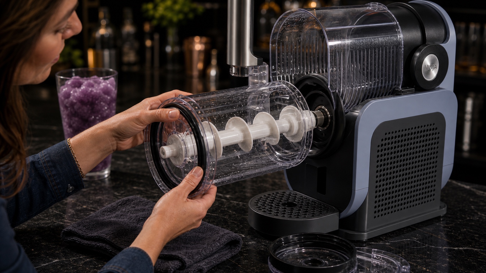 Hands checking the auger and bowl seating on a Ninja SLUSHi-style machine with the chamber removed.
